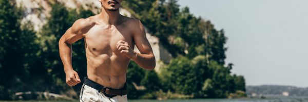handsome-shirtless-man-jogging-on-sandy-beach-2022-12-16-15-55-07-utc-min